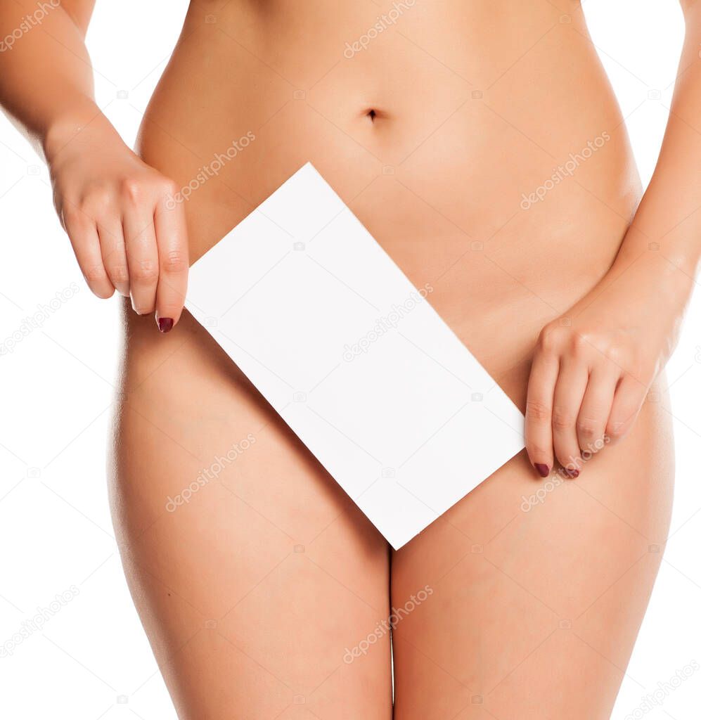 Female covers her pubic area by white empty sign on white background