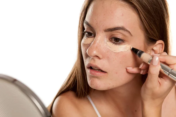 Young Beautiful Girl Applying Concealer Her Eyes White Backgeound — Stock Photo, Image