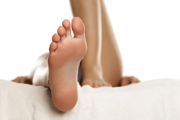 Young female sole feet on white background