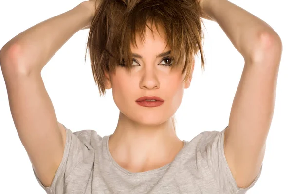Mladá Žena Make Upem Drží Vlasy Bílém Pozadí — Stock fotografie