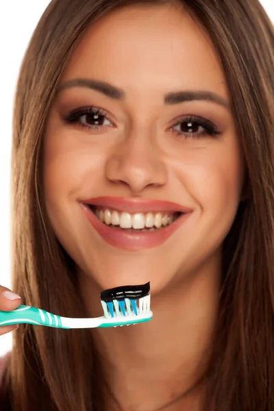 Young Woman Brushing Her Teeth Black Active Charcoal Toothpaste White — Stock Photo, Image