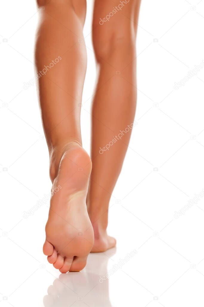 Beautiful woman legs and feet on white background