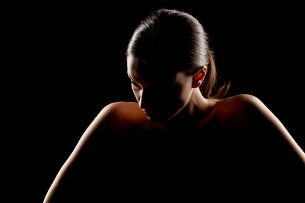 silhouette portrait of a woman on a black background