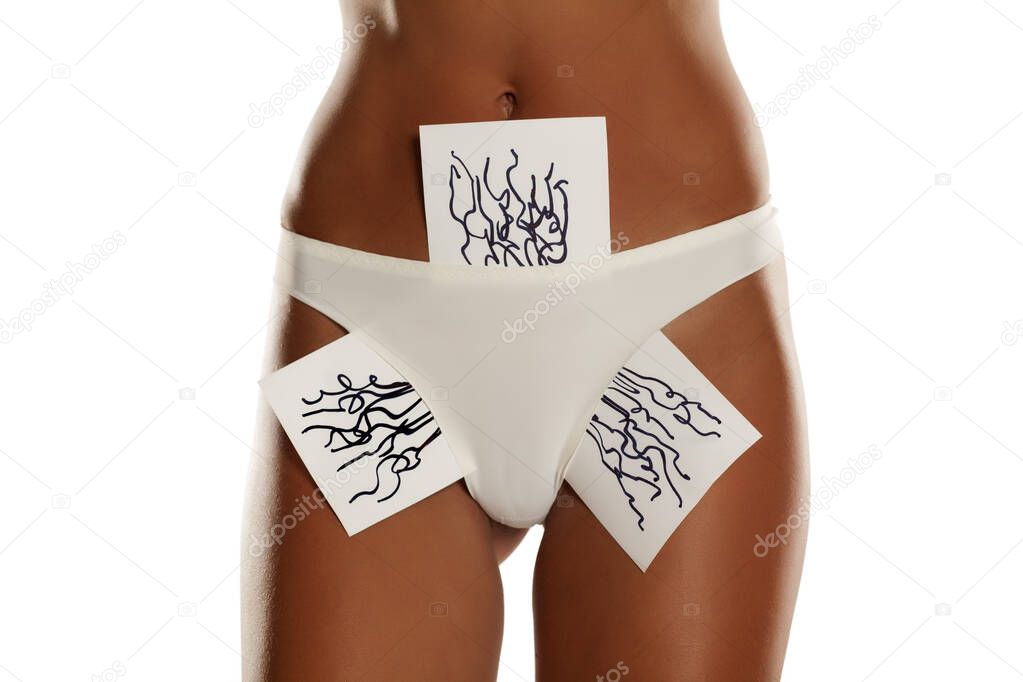 Woman with panties showing her pubic hair drawn on sheet of paper on white background