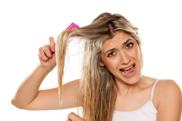 Desperate Blond Woman Combing Her Messy Wet Hair White Background — Stock Photo, Image