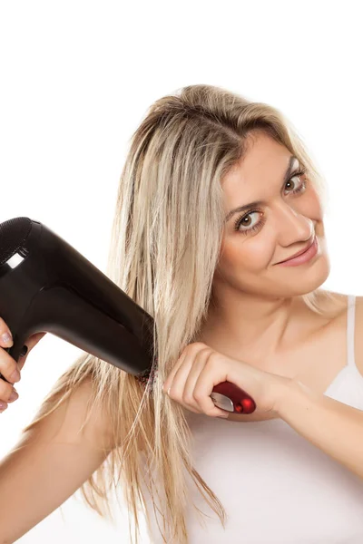 Smiling Young Woman Drying Her Hair Hair Dryer White Backgrund — Stock Photo, Image