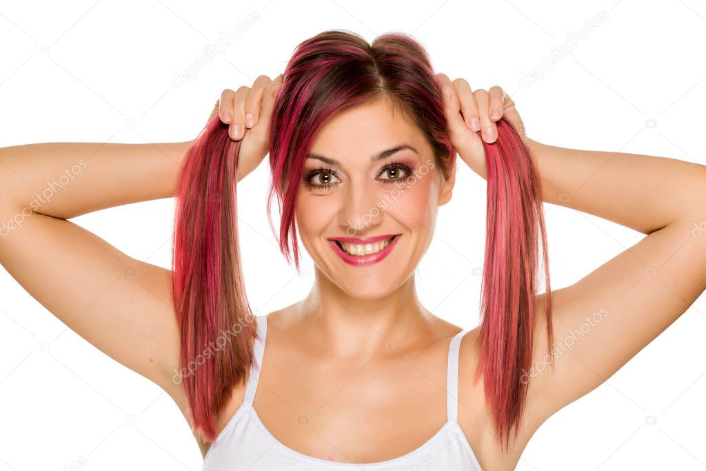 young funny woman with pink hair on white background