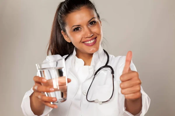 Mulher Sorridente Médico Segurando Copo Água Mostrando Polegares Para Cima — Fotografia de Stock