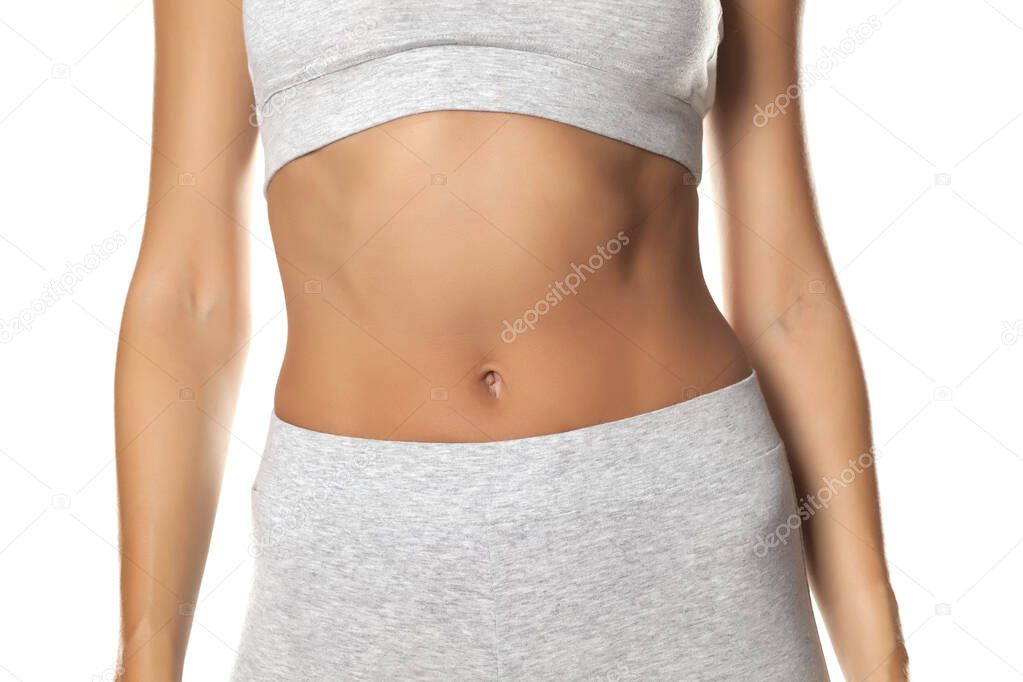 sexy slim female belly on white background