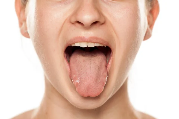 Junge Frau Mit Ausgestreckter Zunge Auf Weißem Hintergrund — Stockfoto