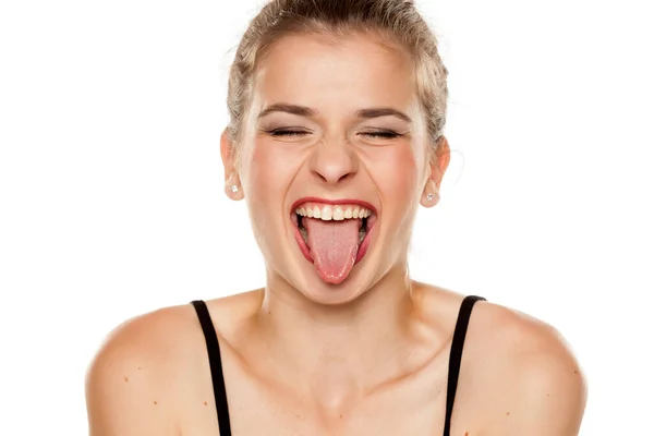 Junge Frau Mit Ausgestreckter Zunge Auf Weißem Hintergrund — Stockfoto