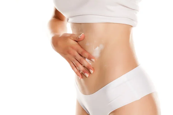 Young Woman Applying Cream Her Belly White Background — Stock Photo, Image