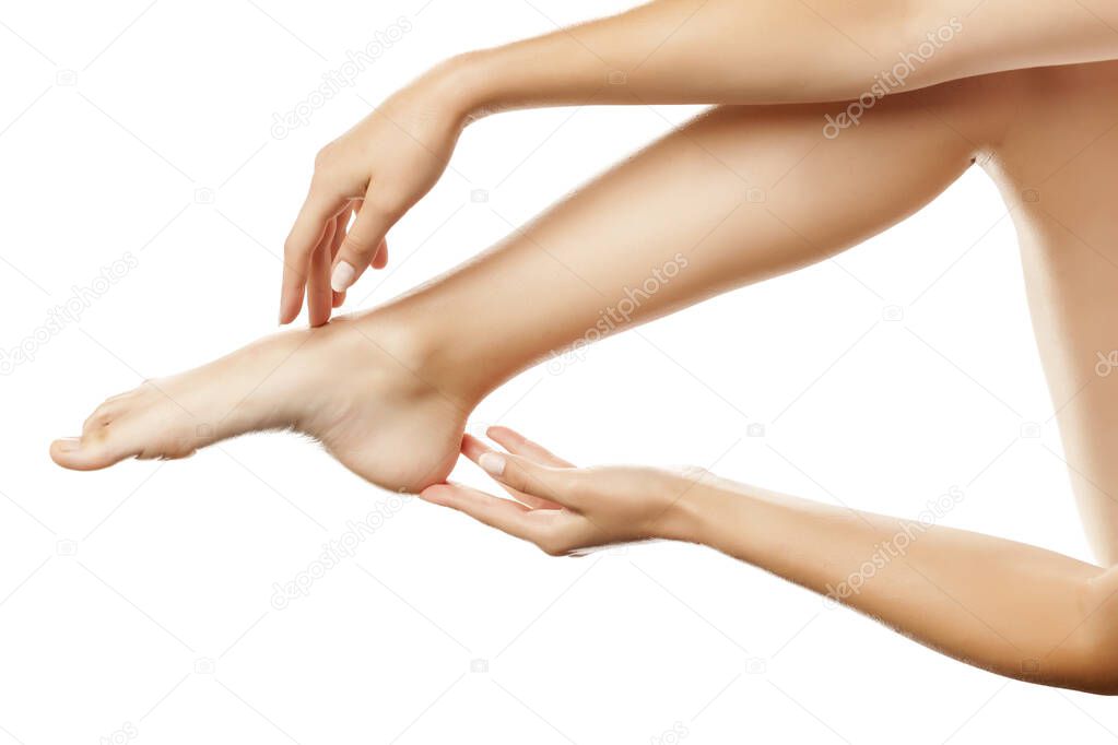 closeup of female hands toush the leg on white background