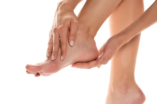 Woman Applying Lotion Her Feet White Background — Stock Photo, Image