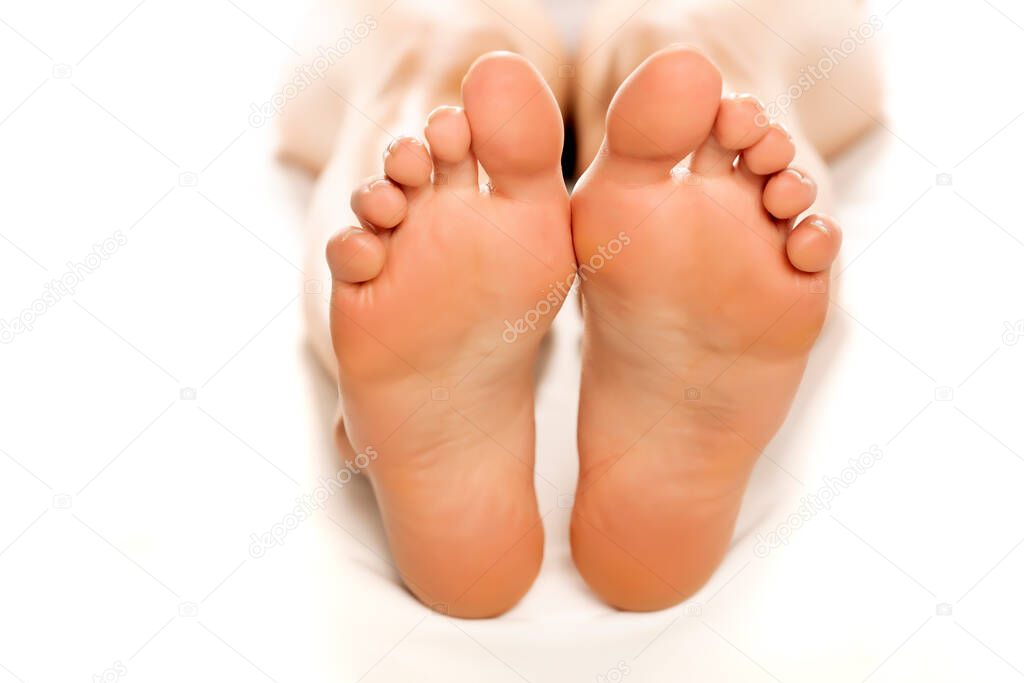 closeup of female sole feet, on white background