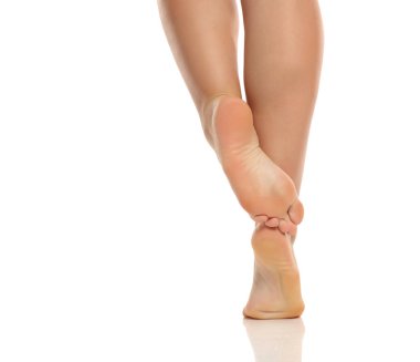 Stüdyo resmi, şişman obez artı çapraz ayaklı kadın bacakları beyaz arka planda dikiz aynasından poz veriyor.