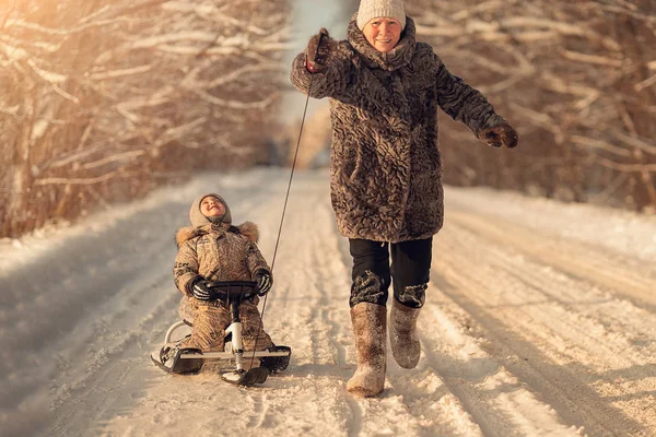 Happy Grandmother Riding Grandson Sleigh Forest — Stock Photo, Image