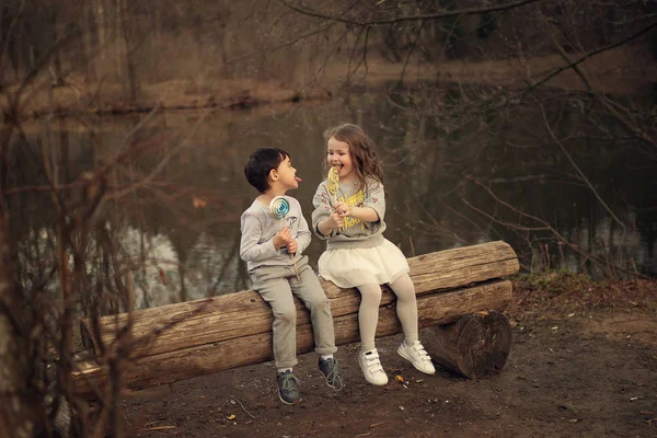 Children Eating Lollipops Sitting Wooden Bench Park — Stock Photo, Image