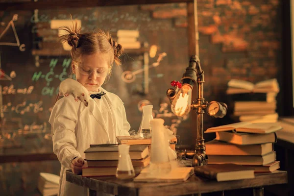 schoolgirl with rat on the shoulder studying in the lab