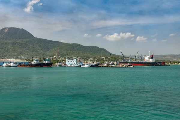 Ships, boats, containers, industrial buildings at the Puerto Plata harbor, port and cityscape, Dominican Republic