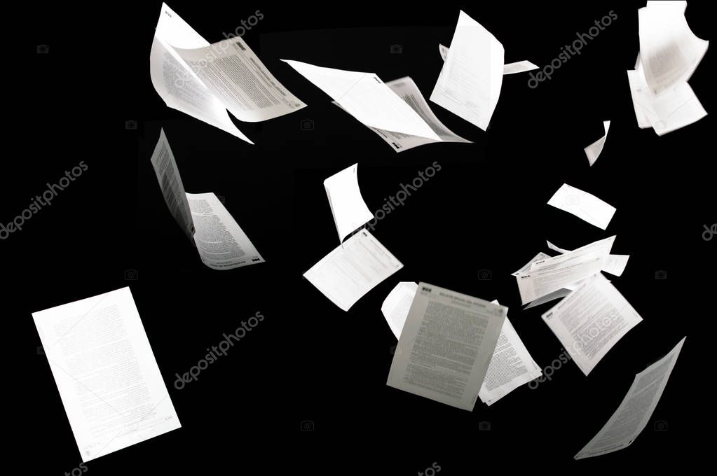 Many flying business documents isolated on black background