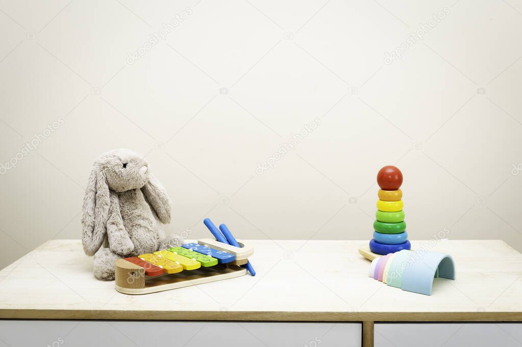 Background of Colorful Children's toys against the wall Toys on Wood Table with Copy Space for Text