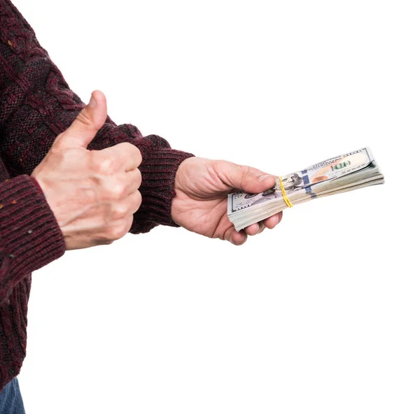 Mann hält Packung Dollarscheine in der Hand — Stockfoto