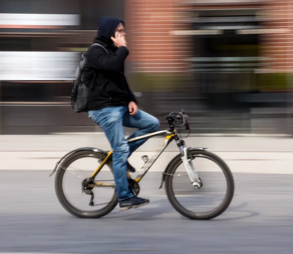 Cyclist on the city roadway in motion blur — Stock Photo, Image