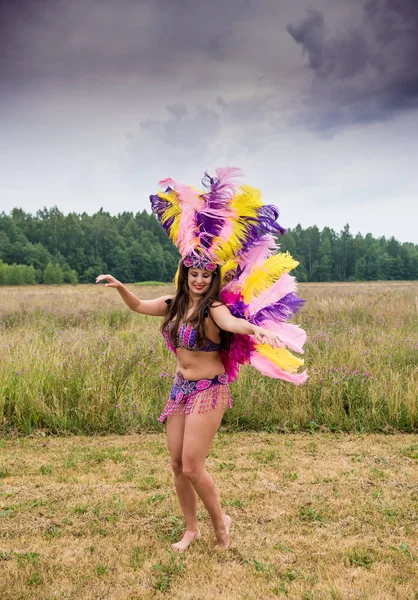 Young girl in bright colorful carnival costume posing outdoors — Stock Photo, Image