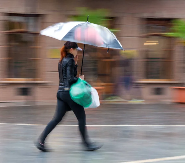 People with umbrella walking down the street on rainy day