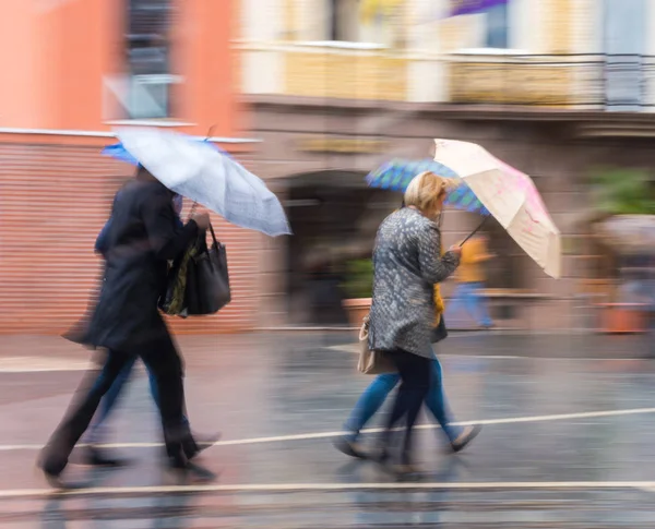 Emberek esernyő sétál az utcán, esős napon — Stock Fotó