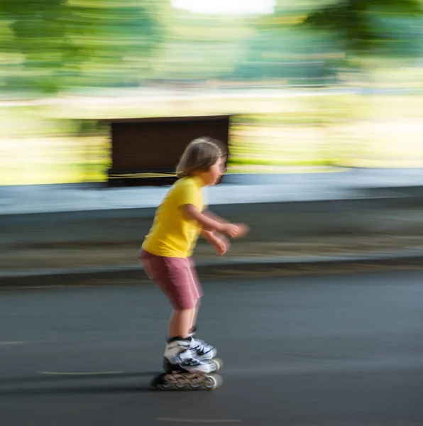 Boy on rollerblades skating in motion blur — Stock Photo, Image