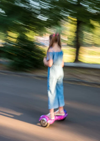 Girl riding on the hoverboard in the park — Stock Photo, Image