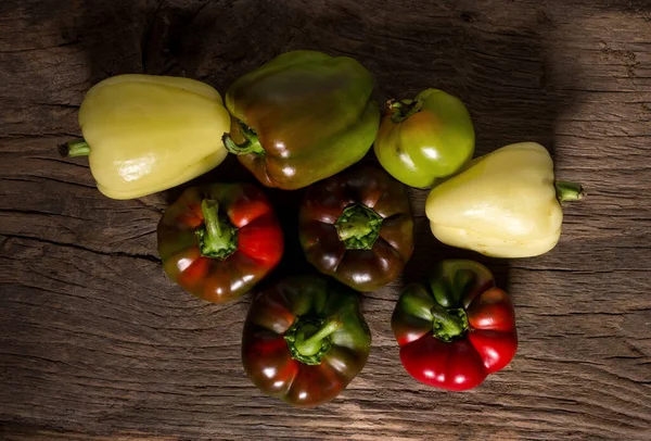 Peppers on rustic wooden table — Stock Photo, Image