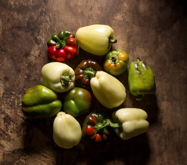 Peppers on rustic wooden table — Stock Photo, Image