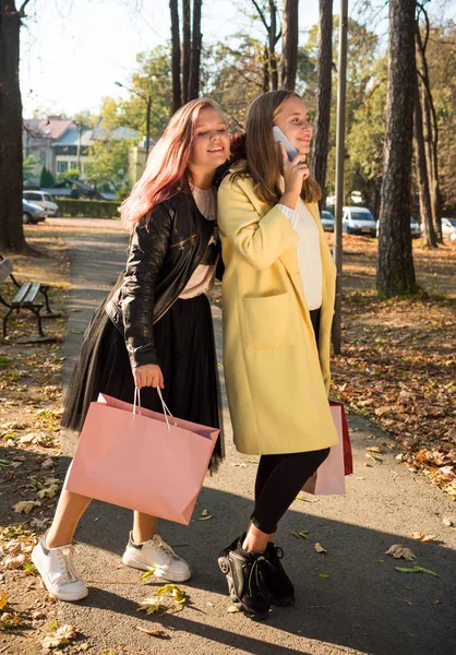 Beautiful teenage girls having fun in autumn street in suuny day — Stock Photo, Image