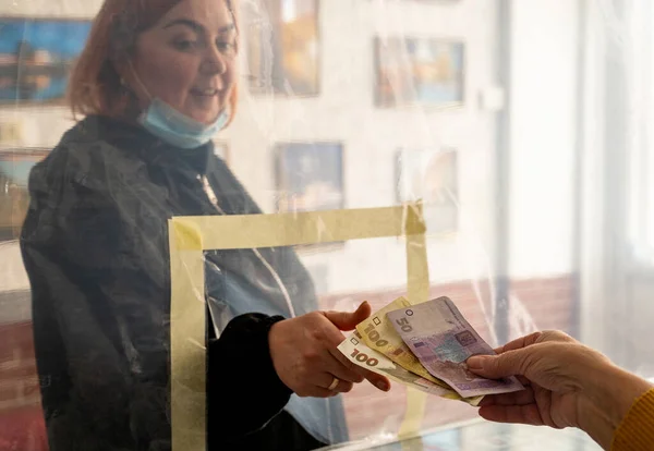 靠近塑料屏障的女人在结帐处付钱 乌克兰的检疫 Covid 19大流行病 — 图库照片