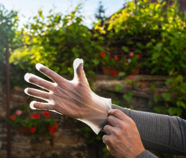 Man in disposable gloves outdoors. Man wearing gloves clipart