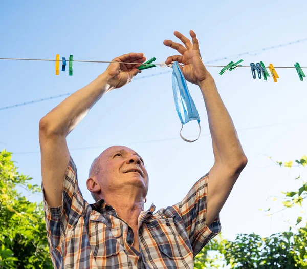 Senior Man Hangs Washed Masks Rope — Stock Photo, Image