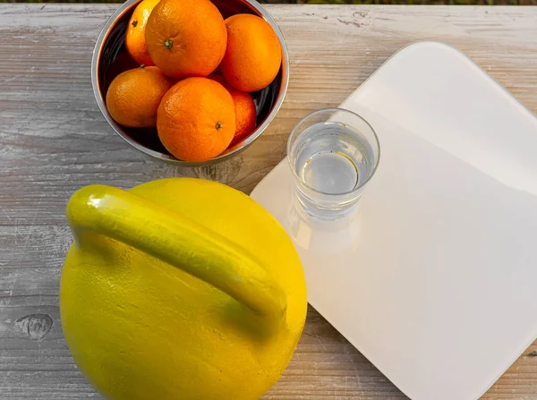 Kettlebell Tangerines Scales Glass Water Wooden Table — Stock Photo, Image