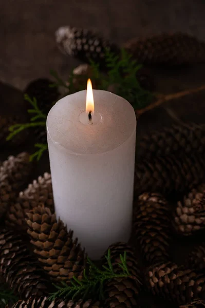 Vánoční Svíčka Světlem Jedle Kužely Přes Tmavé Pozadí — Stock fotografie