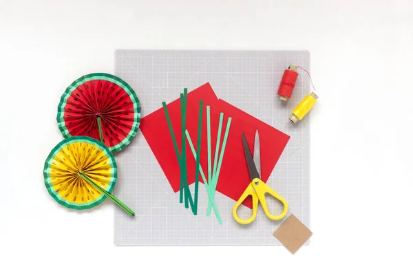 DIY instruction. Step by step tutorial. Making decor for summer birthday party - red and yellow watermelon fan. Craft tools and supplies. Step 2 — Stock Photo, Image