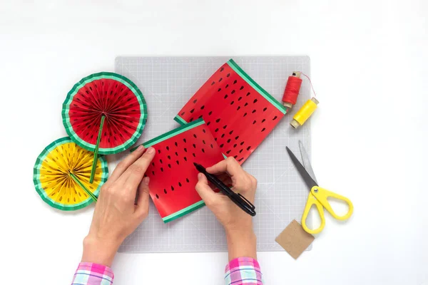 DIY instruction. Step by step tutorial. Making decor for summer birthday party - red and yellow watermelon fan. Craft tools and supplies. Step 4 — Stock Photo, Image