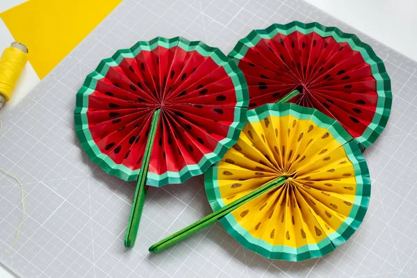 DIY instruction. Step by step tutorial. Making decor for summer birthday party - red and yellow watermelon fan. Craft tools and supplies. Step 8 - Final — Stock Photo, Image