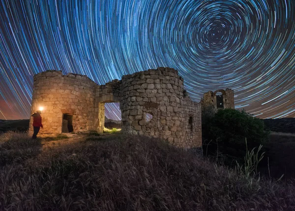 Star trail over an old castle