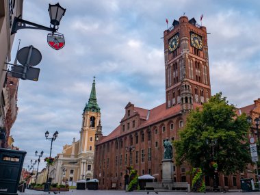 Medieval Town Hall in the Old Town of Torun with the monument of astronomer Nicolaus Copernicus. clipart