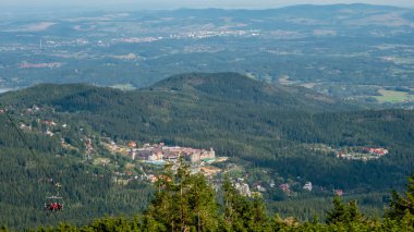 Mountain landscape with trees and meadow - Giant Mountains, Karkonosze, Poland. Karpacz City with view of the Golebiewski hotel.