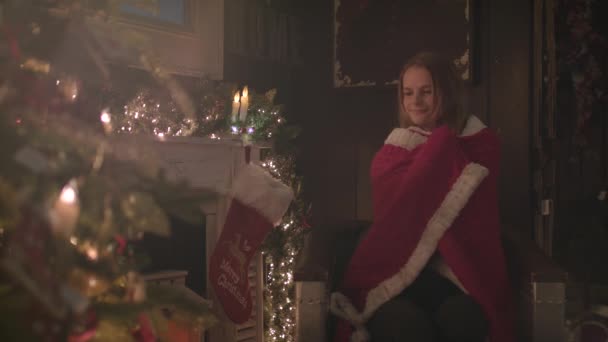 Beautiful Girl Wrapped Cozy Blanket Sitting Next Christmas Tree — стоковое видео