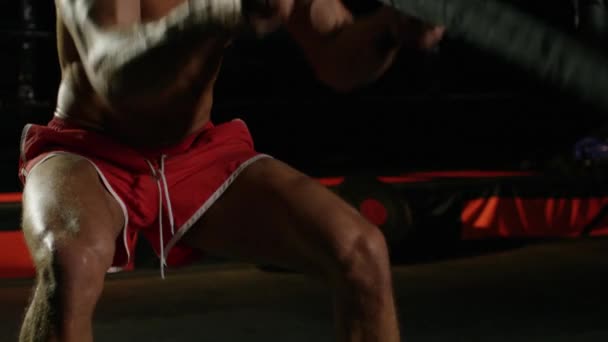 Young Man During The Boxing Training On The Dark Background Warming Up With The Battle Ropes Shot On RED Camera — Stock Video