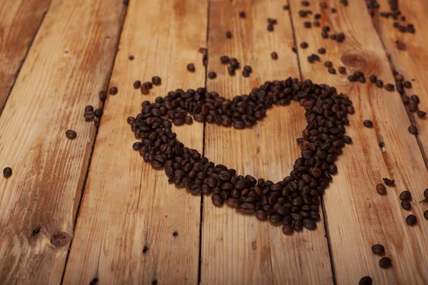 heart and coffee on a wooden table as background